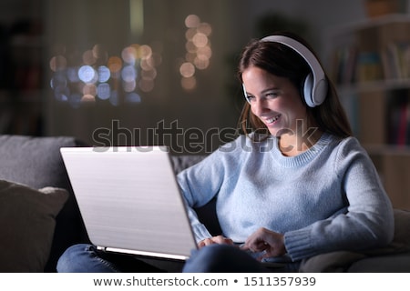 Foto stock: Content Woman Listening To Music At Home