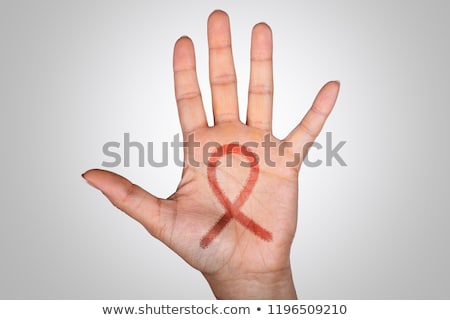 ストックフォト: Close Up Of Uterine Cancer Awareness Ribbon Drawn On Female Hand