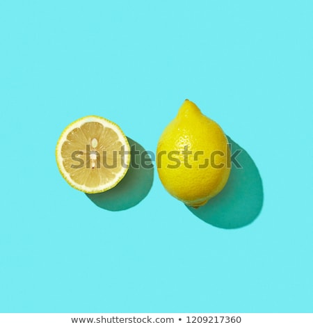 Half A Juicy Lemon On A Blue Background With Shadow And Copy Space Ingredient For Drink Top View Сток-фото © artjazz