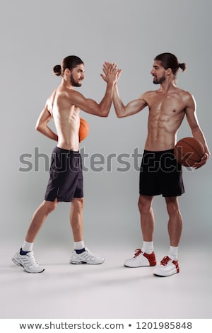 Foto stock: Full Length Portrait Of A Two Muscular Shirtless Twin Brothers
