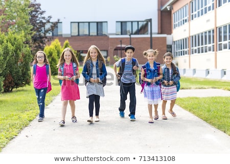 Foto stock: Great Group Portrait Of School Pupil Outside Classroom Carrying Bags