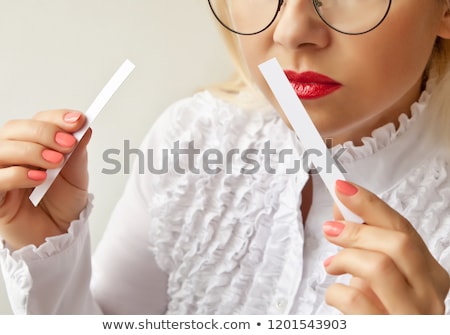 Stock foto: A Woman With Paper Strips In Her Hands Listens To The Fragrance