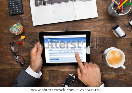 Foto stock: Man Filling Online Survey Form On Digital Tablet