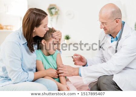 Stock foto: Contemporary Pediatrician Making Injection To Little Girl In Hospital