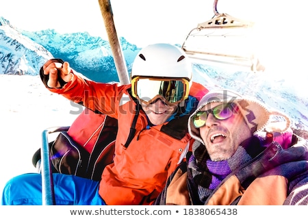 Foto stock: People In Chairlift With Bright Sun