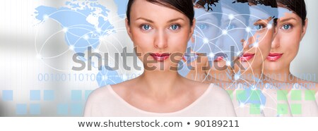 Foto stock: Many Identical Businesswomen Clones In Front Of Digital Transpar