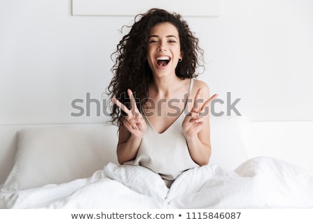 Stock photo: Portrait Of Young Woman Relaxing On Bed
