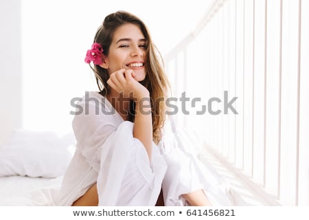 Сток-фото: Beautiful Woman With Hand In Her Hair Sitting In Bed