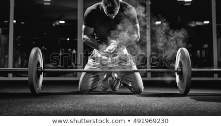 Foto stock: Attractive Strong Fitness Guy Lifting Weight