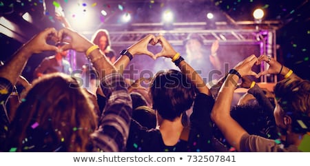 ストックフォト: Fans Making Heart Shape With Hands At Nightclub