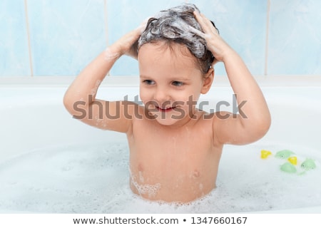 Foto d'archivio: Boy Taking Bath In Bathtub