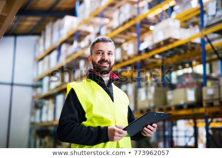 Stock photo: Warehouse Worker With Clipboard In Safety Vest