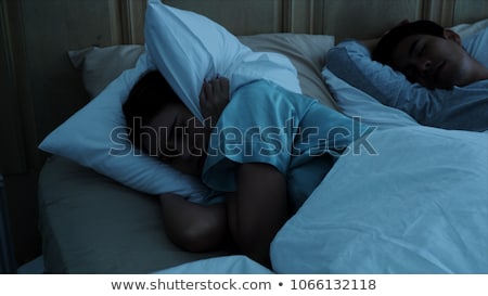 Foto d'archivio: Couple Disturbed By Noise On Bed