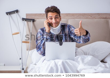 ストックフォト: The Injured Man Chatting Online Via Webcam In Bed At Home