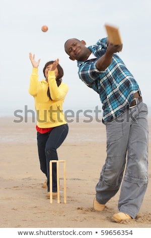 Foto stock: Young Man Playing Cricket On Autumn Beach Holiday