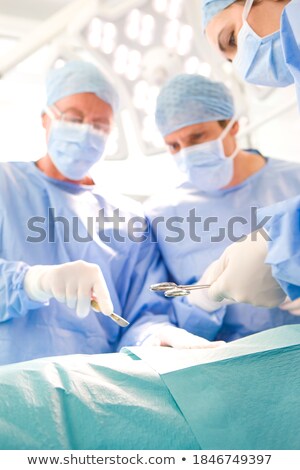 Foto stock: Surgery In A Modern Hospital Being Performed By A Team