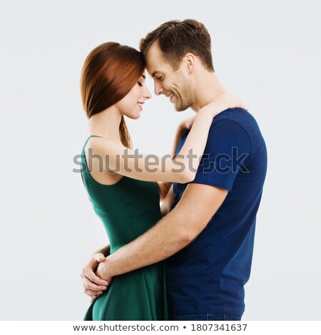 ストックフォト: Young Smiling Woman In Casual Dress Touching Her Head On Gray Background