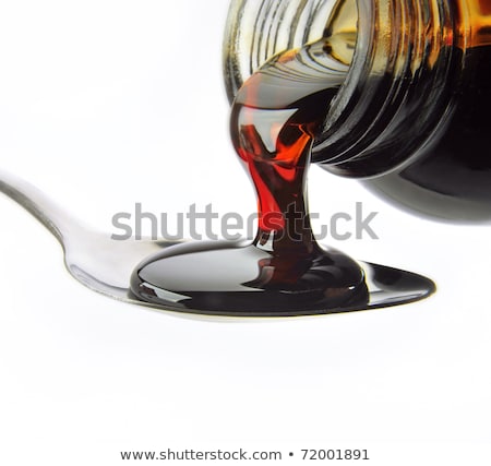 Foto stock: Close Up On A Medicine Bottle With Red Syrup Isolated On A White