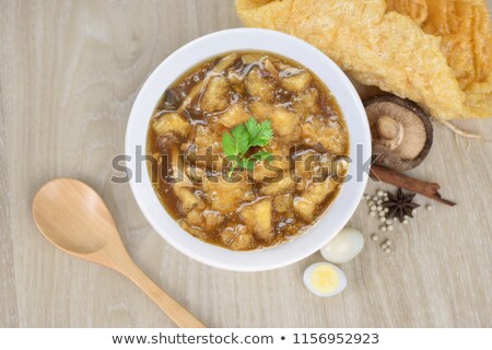 Stock photo: Braised Fish Maw In Red Gravy With Crab In Bowl On Wood Backgrou