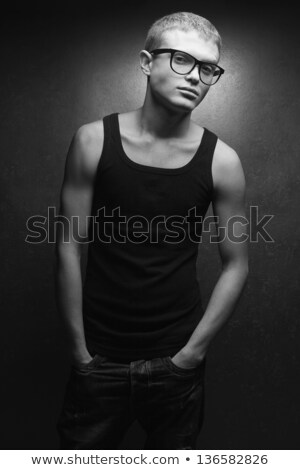 Stock photo: Young Blonde Hipster Wearing Glasses Posing With Hand In Pocket