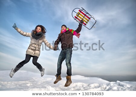 Stok fotoğraf: Man And Woman Jumping Up On Mountain