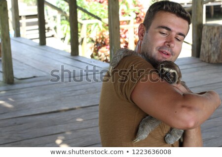 Foto stock: A Male Veterinarian With Sloth At Zoo