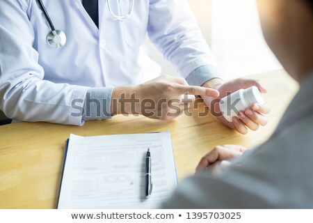 [[stock_photo]]: Therapist Consulting To Patient Male Patient About Pills Writing