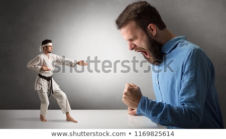 Stockfoto: Giant Man Yelling At A Small Karate Man