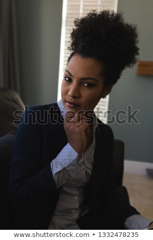 Stock fotó: Portrait Of A Thoughtful Young Female Real Estate Agent Relaxing On Sofa At Home