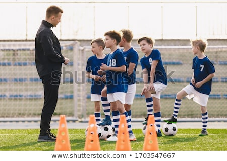 Young Coach Explaining Training Rules To Children School Soccer Stockfoto © matimix