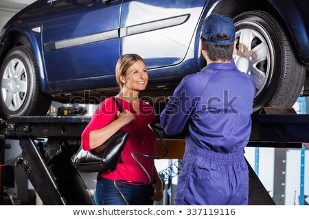 [[stock_photo]]: Female Mechanic Changing Tires