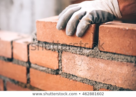 Foto stock: Bricklayer Working In Construction Site Of A Brick Wall