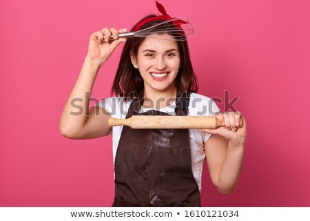 Zdjęcia stock: Portrait Of A Woman Holding A Rolling Pin And Smiling