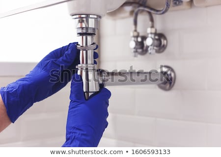 Foto stock: Plumber Fixing The Sink Siphon In A Bathroom Or Kitchen