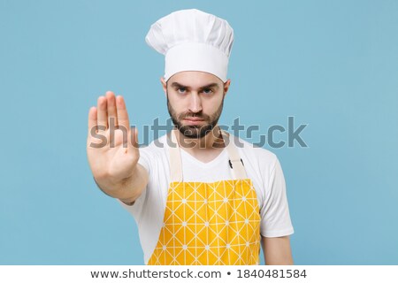 Stock fotó: Serious Man In Blue Shirt And Hat Showing Stop Gesture