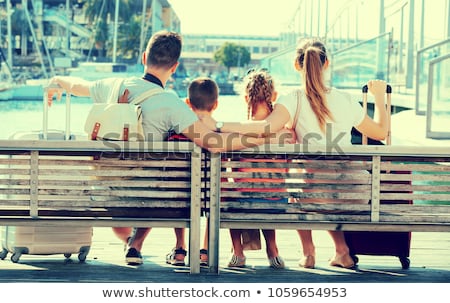 Stok fotoğraf: Boy And Girl Sitting On Promenade