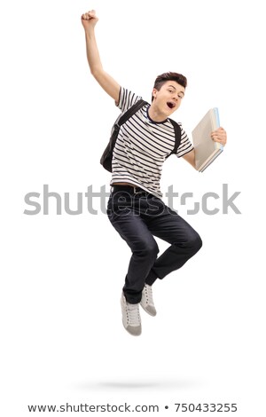 Stok fotoğraf: Teenage Boy Jumping With Books