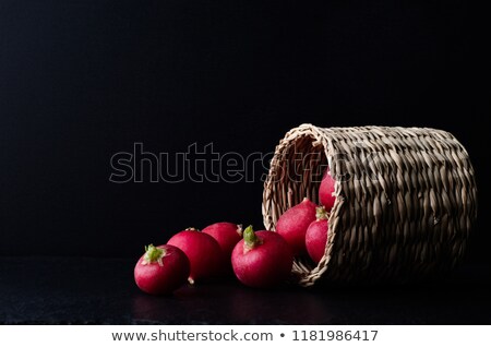 Basket Of Radishes Spilling On To Slate With Black Background Stock foto © Frannyanne