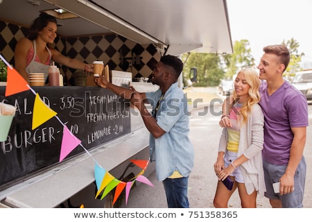 Foto d'archivio: Customers Queue And Saleswoman At Food Truck