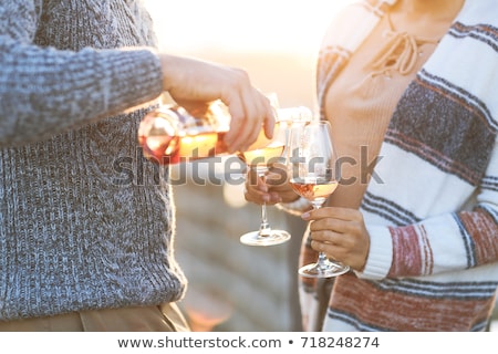 [[stock_photo]]: Man And Woman With Glass Of Rose Wine On Beach Picnic