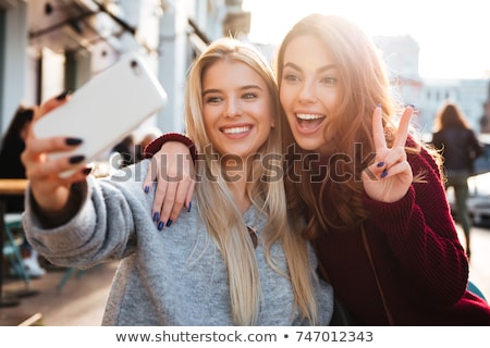 Stock foto: Two Friends Women Outdoors Take A Selfie
