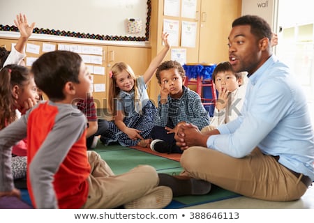 [[stock_photo]]: Side View Of Schoolgirls Raising Hand In Classroom Of Elementary School