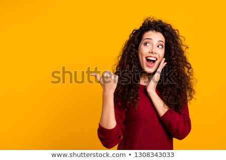 Foto d'archivio: Photo Of Happy Young Woman Smiling And Pointing Her Cheeks