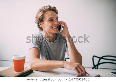 Stok fotoğraf: Young Smiling Man Talking On The Phone