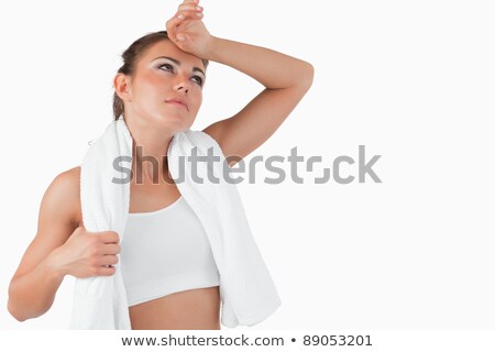 Сток-фото: Sporty Woman Wiping Off Sweat Of Her Forehead Against A White Background