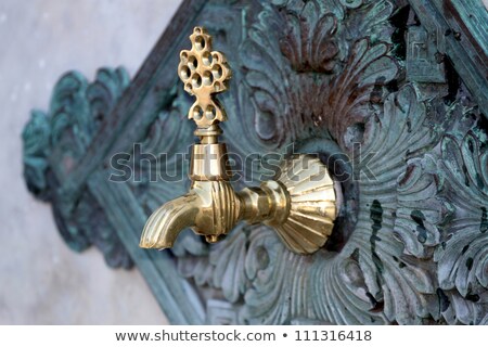 Foto stock: Old Marble Fauntain With Brass Faucet
