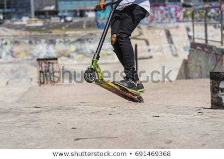 Foto stock: Boy Jumps With His Scooter At The Skate Park