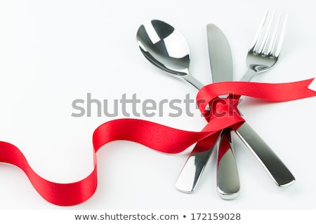 Foto d'archivio: Fork Spoon And Knife Tied Up With Red Ribbon