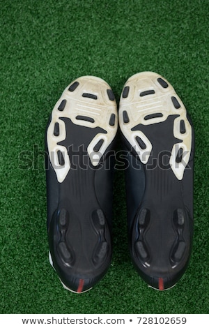 Stockfoto: Cleats Kept Upside Down On Artificial Grass