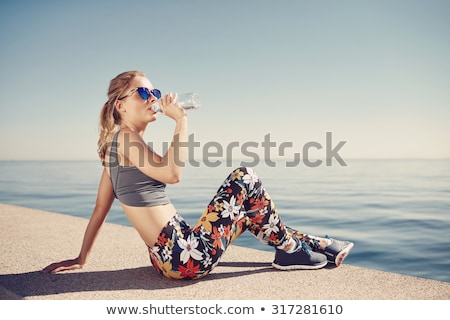 ストックフォト: Pretty Young Woman Takes A Break After Running